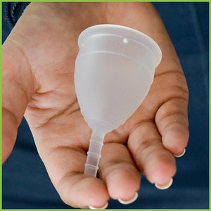 A close up of a menstrual cup from Lunette being held in a women's hand.