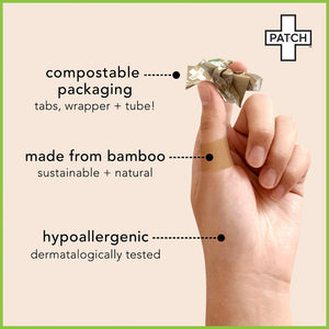 A hand with a PATCH bamboo plaster wrapped around the thumb. The hand is also holding the plasters wrapping. Text reads: Compostable packaging. Made from Bamboo. Hypoallergenic.