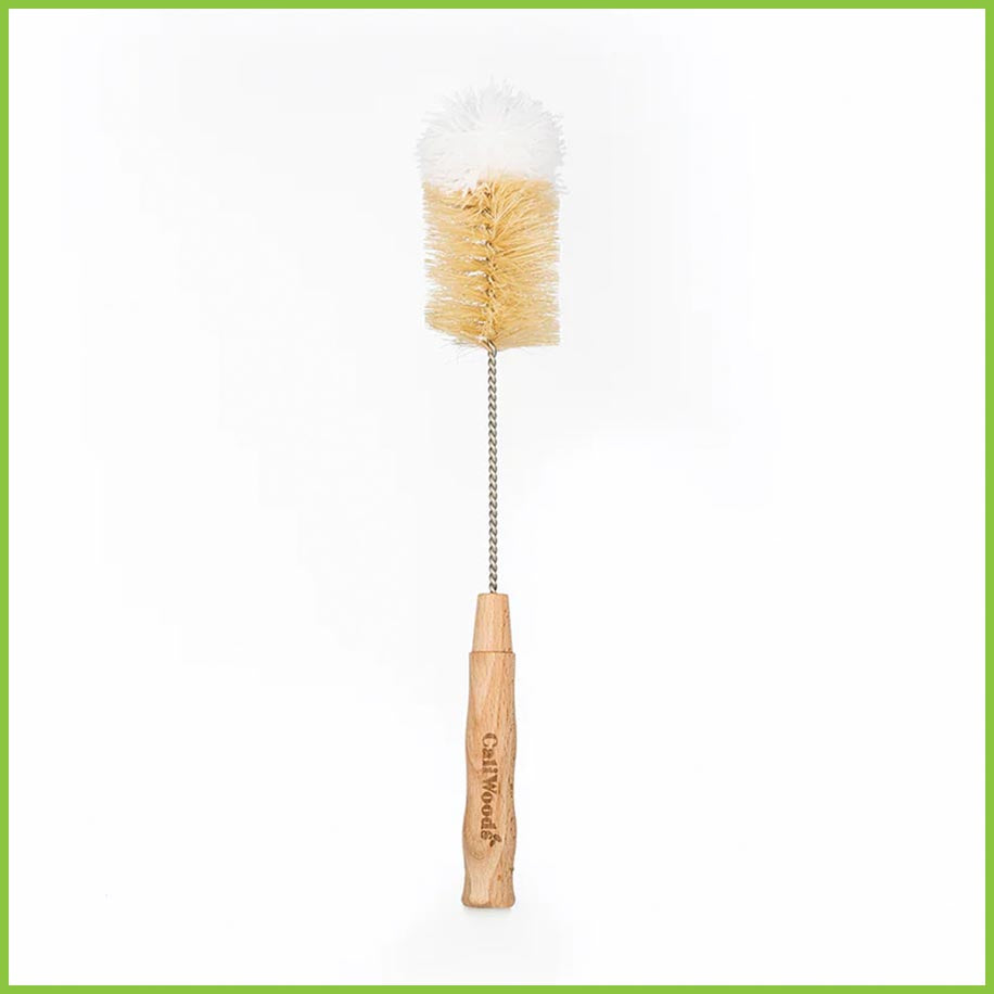 A CaliWoods bottle brush standing up vertically. It is a product shot on a white background. The bottle brush has a bamboo handle, a stainless steel wire and plant fibre bristles. The end of the bottle brush has a soft white cotton end.