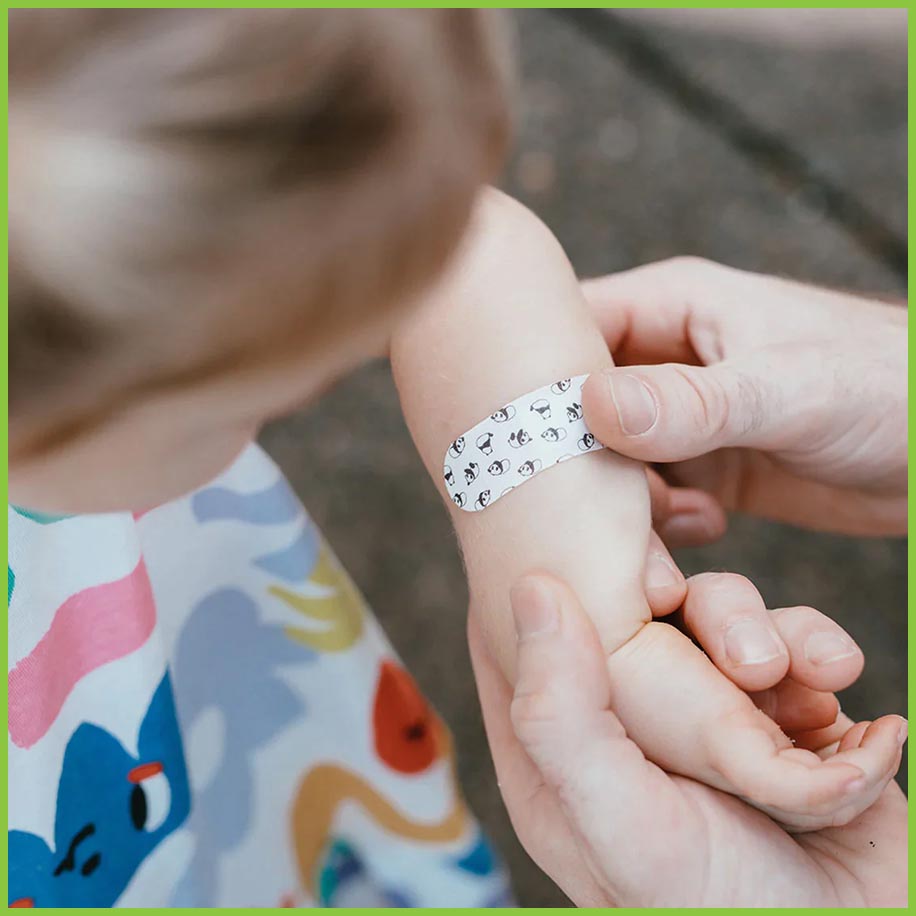 A toddler having a panda plaster from PATCH applied to their arm.