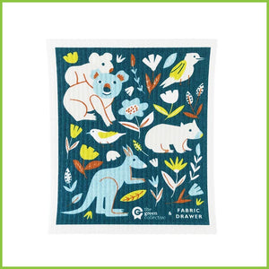 A Spruce Swedish dish cloth with the 'Save The Animals' design. The cloth is a dark green/blue with Australian animals on it such as the kangeroo, koala, kookaburra and wombat. 