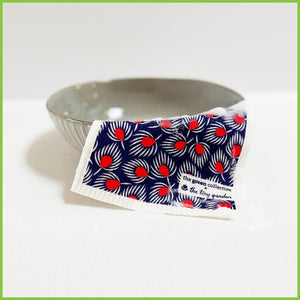 A Spruce Swedish dish cloth with the Fan Feathers design draped over a small bowl.