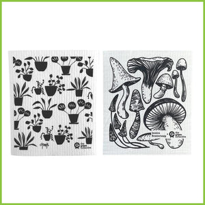 Two Swedish patented dish cloths. One with a black and white pot plants design and the other with a black and white mushroom design.