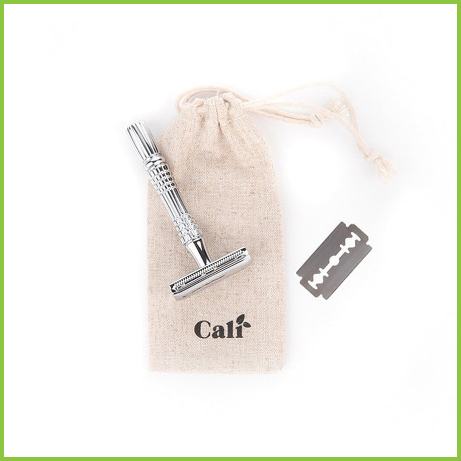 A drawstring travel bag for a safety razor with a silver razor lying on top of it.