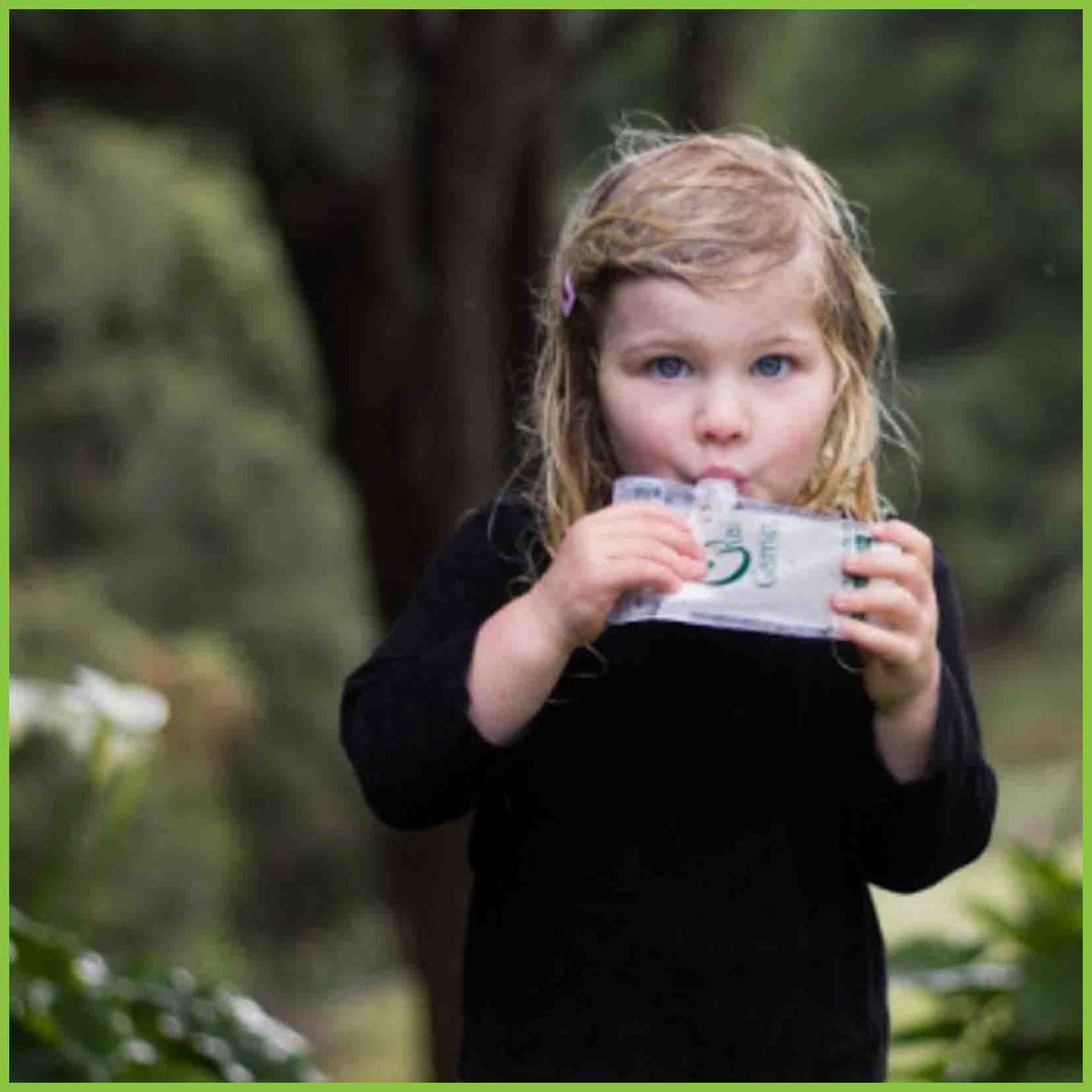 A young child eating from a Kai Carrier food pouch.