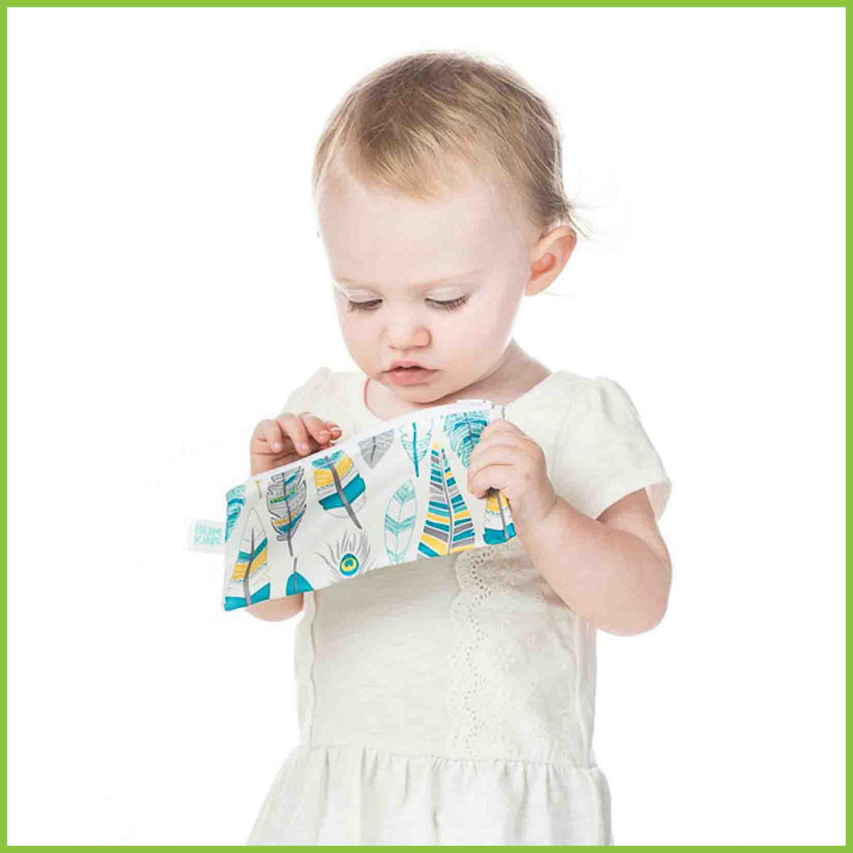 A toddler reaching into a Bumkins snack bag.