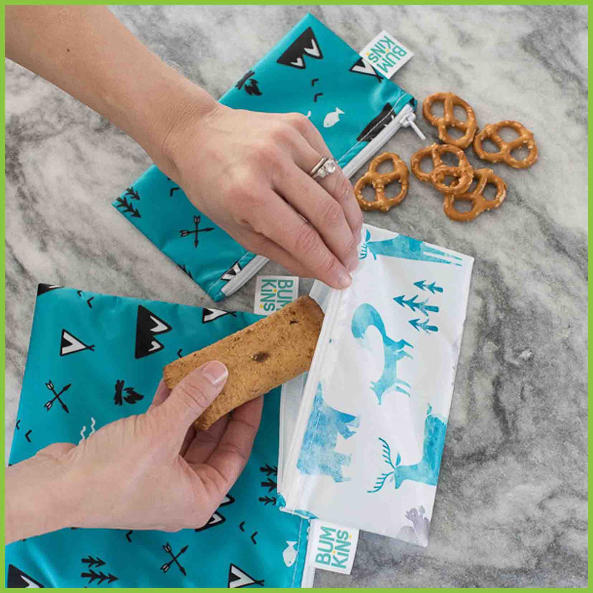 An adult putting food into a Bumkins snack bag.