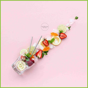 Caliwoods cocktail straws in a glass with fruit