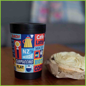 A reusable cup by CuppaCoffeeCup with the Straight Coffee design sitting on a table.