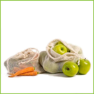 Organic cotton veggie bags from Rethink holding some carrots and apples.