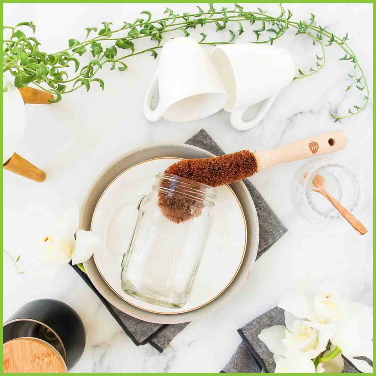 A wooden bottle brush cleaning a glass jar.