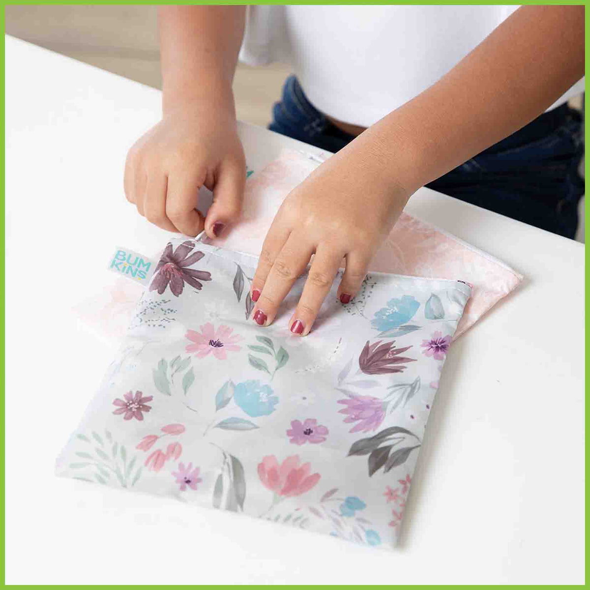 Two Bumkins large snack/sandwich bags in the Floral and Lace designs, with one bag being zipped closed.