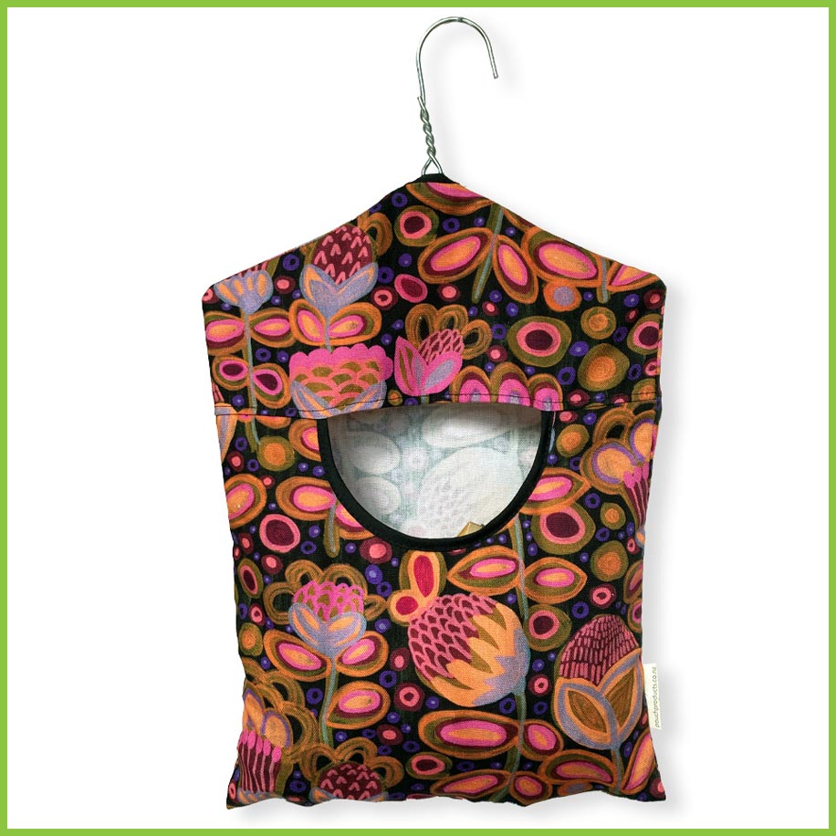 A cotton peg bag with a stainless steel hanger for ease of use. Peg bag has a bright and bold painted flowers print.