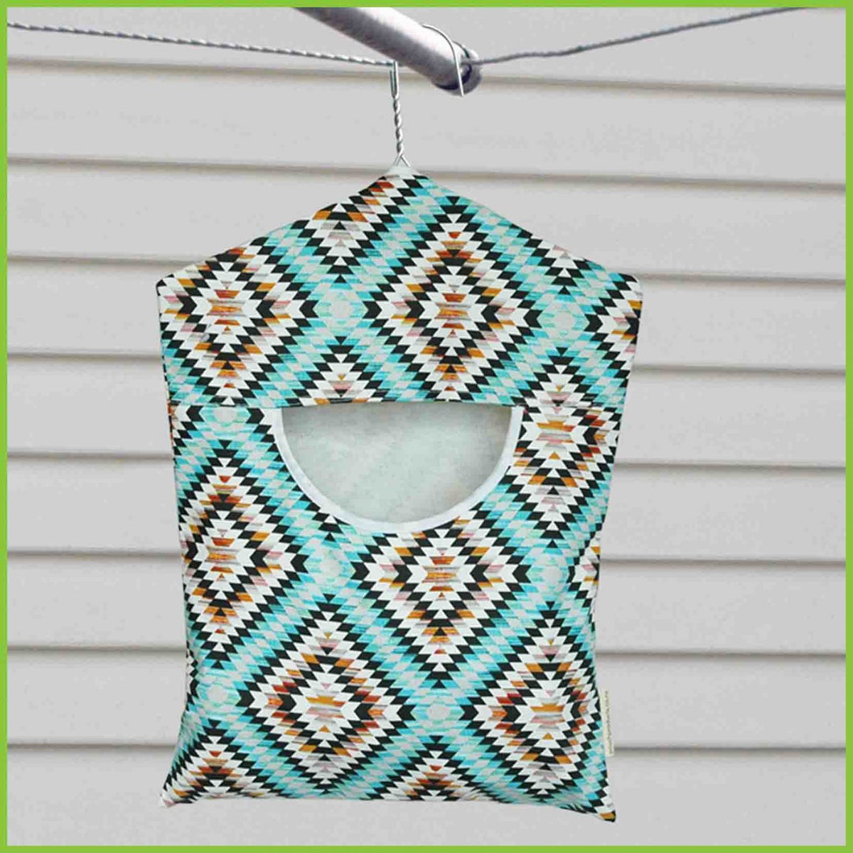 A cotton peg bag with an abstract aztec design in blue and grey.
