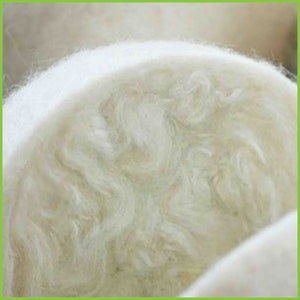 A cut wool dryer ball to show you the felted wool goes all the way through the ball.