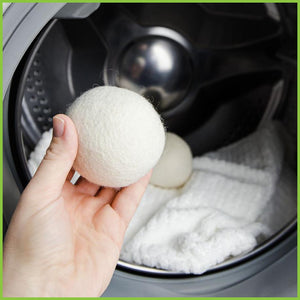 A wool dryer ball about to be put into a dryer.