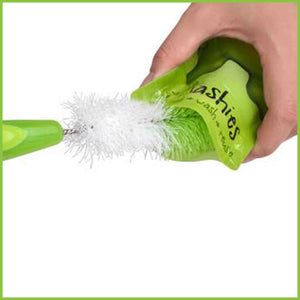 A bottle brush cleaning the inside of a Little Mashies reusable food pouch.
