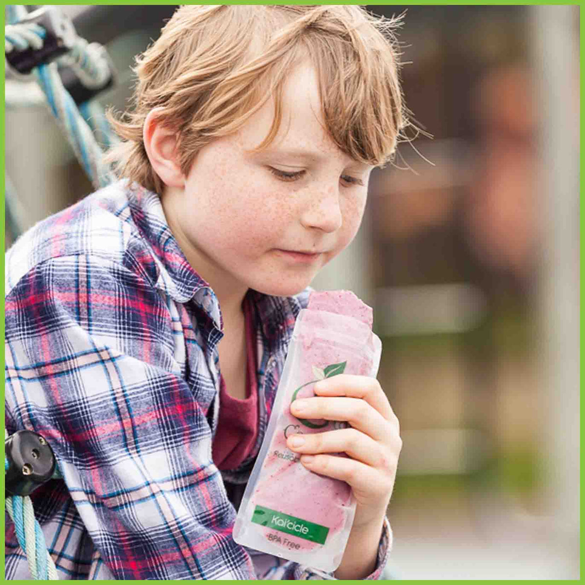 A boy eating from a Kai Carrier ice block pouch.