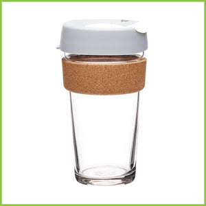 A large KeepCup cork cup with a grey and white. lid and a cork band.