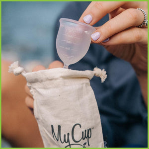 A My Cup menstrual cup being put into it's travel bag.