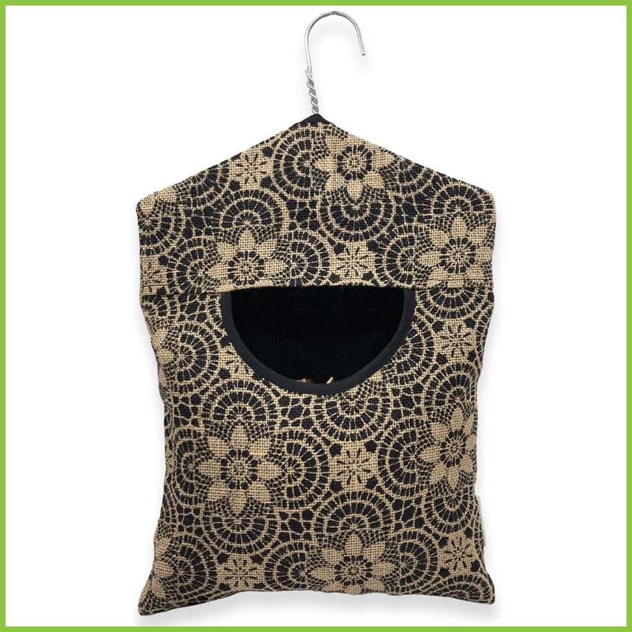 A peg bag made from jute and cotton with a stainless steel hanger. The bag has a bold yet pretty geometric floral pattern.