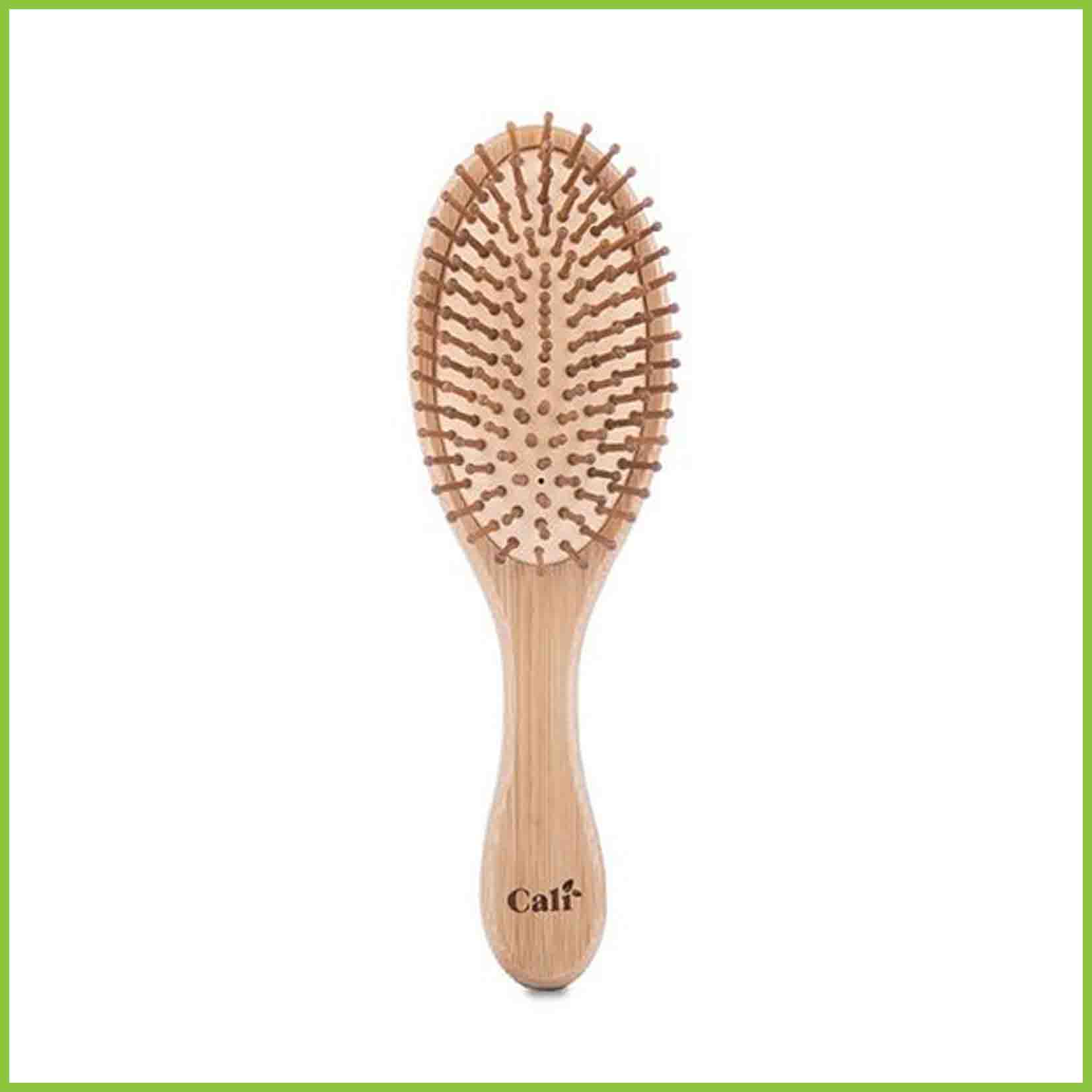 Bamboo and natural rubber hair brush, front facing on a white background.