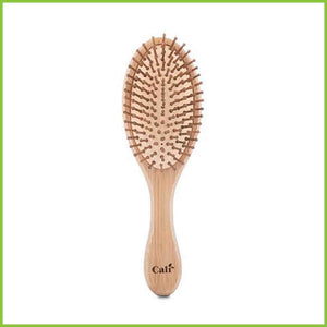 Bamboo and natural rubber hair brush, front facing on a white background.