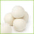 Wool dryer balls stacked on a white background.