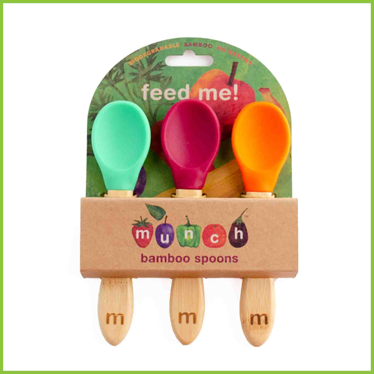 A pack of 3 soft silicone baby feeding spoons. These spoons are from the brand 'Munch', have bamboo handles and silicone tips in three different colours, green, red and orange. The spoons are packaged in a simple cardboard holder.