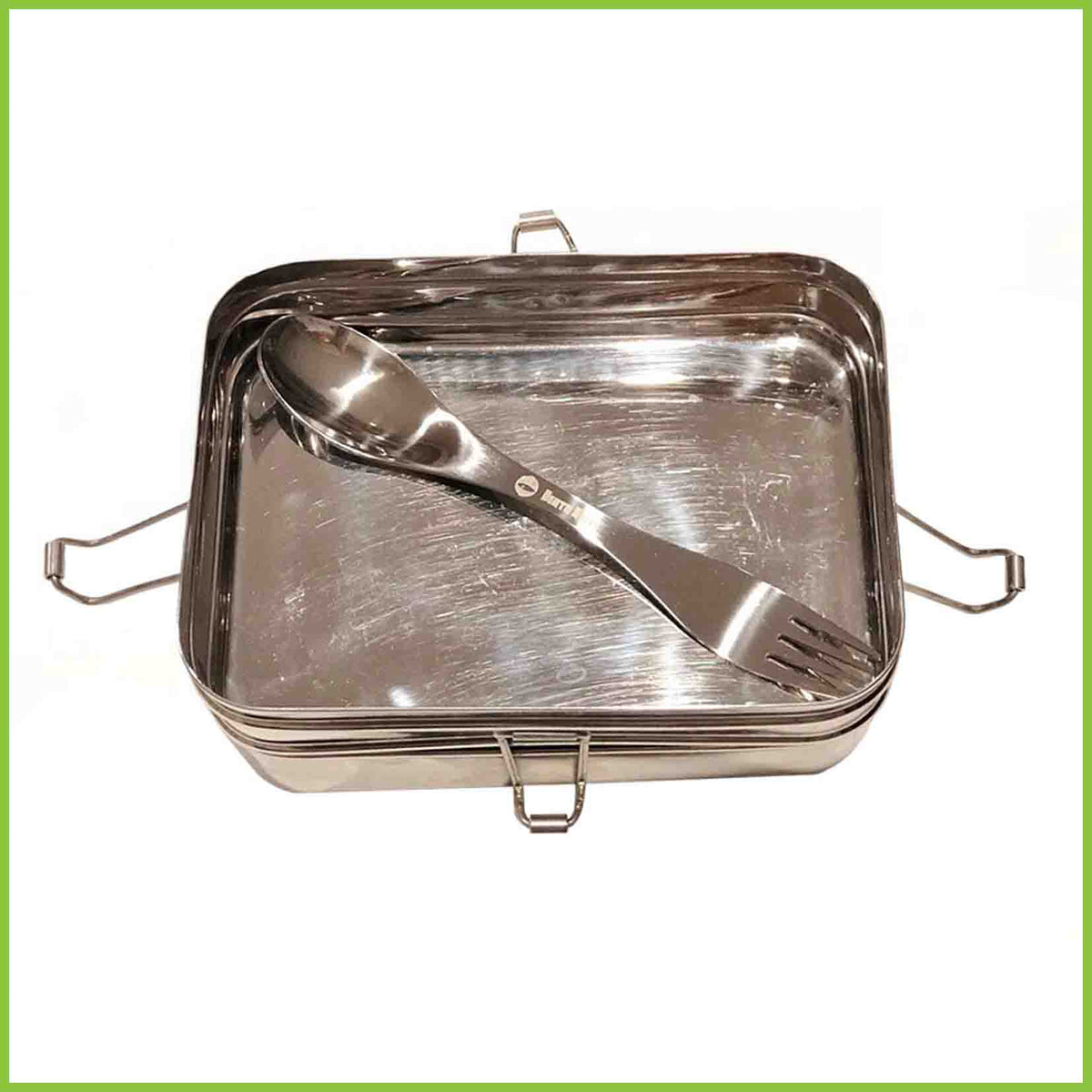 A stainless steel spork lying in a lunchbox. Both items from Bento Ninja.