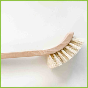A wooden dish brush from The Good Change Store NZ with a close up shot of the head and bristles.